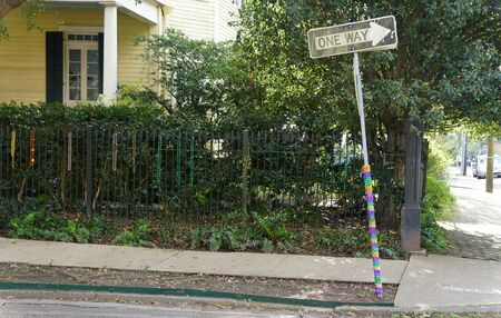 New Orleans, Louisiana, U.S.A - February 8, 2020 - A one way pole and fence decorated with beads near The Garden Districtのeditorial素材