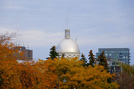 Old Montreal, Canada - October 25, 2019 - The view of the exterior dome of Bonsecours Market overlooking striking colors of fall foliageのeditorial素材