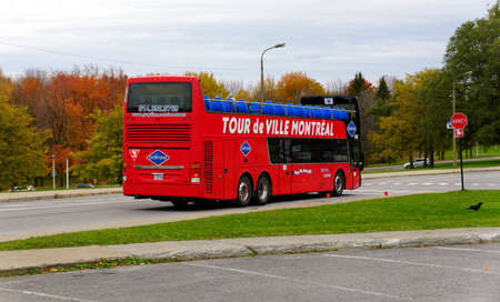 Quebec, Canada - October 27, 2019 - The red bus of Tour de Ville Montreal on the road near Mount Royalのeditorial素材