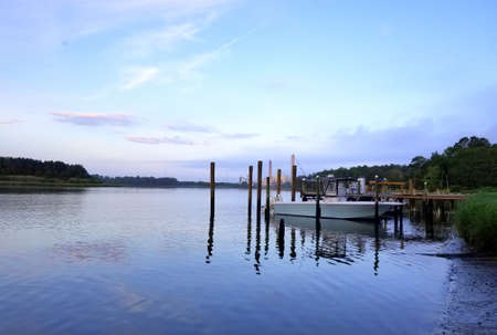Millsboro, Delaware, U.S.A - June 20, 2020 - The view of the bay with boat on the dock during early morningのeditorial素材