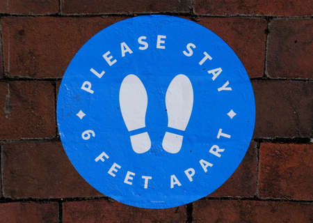 Williamsburg, Virginia, U.S.A - June 30, 2020 - The sticker on the brick walkway asking the...