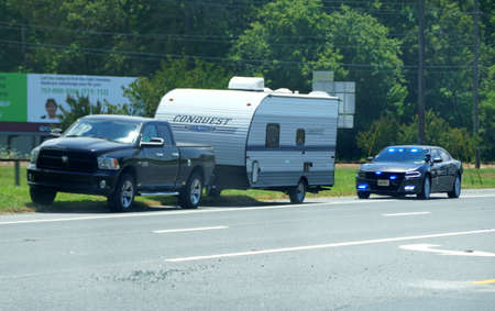 Virginia, U.S.A - June 29, 2020 - A truck carrying a recreational vehicle was pulled over by a cop...