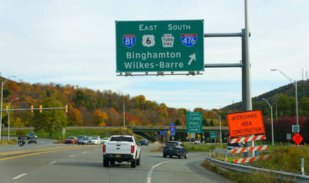 Clark Summit, Pennsylvania, U.S.A - October 20, 2020 - Traffic into Interstate 81, 476, PA Turnpike and Route 6 surrounded by striking color of fall foliageのeditorial素材