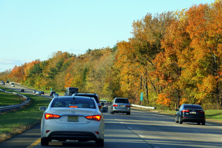 Atlantic City, New Jersey, U.S.A - November 5, 2018 - Cars on the highway with the striking colors of fall foliageのeditorial素材