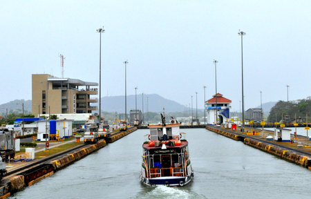 Panama City, Panama - May 9, 2015 - A boat crossing Panama Canal, an artificial waterway that...