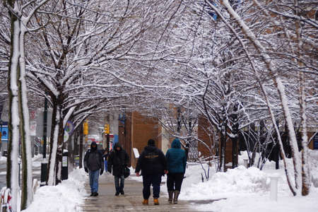 Philadelphia, Pennsylvania, U.S.A - February 2, 2021 - People walking on the street by Jefferson University after a snowstormのeditorial素材