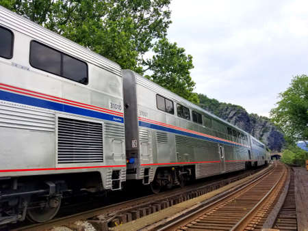Harpers Ferry, West Virginia, U.S.A - June 19, 2021- An Amtrak train stopped by the railway stationのeditorial素材