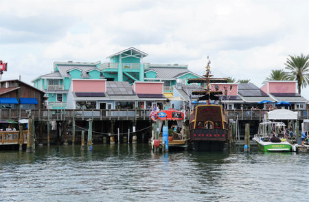 Madeira Beach, Florida, U.S.A - November 8, 2021 - The restaurants and ship on the dock by John's Pass and the canalのeditorial素材
