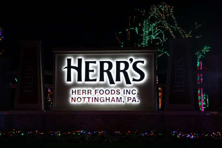 Nottingham, Pennsylvania, U.S.A - December 28, 2021 - The entrance of Herr's Food Inc entrance decorated in colorful lightsのeditorial素材
