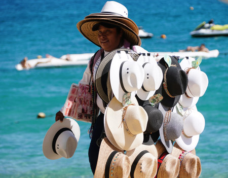 Cabo San Lucas, Mexico - November 7, 2022 - A local salesperson offering varieties of hats for sale on a sunny dayのeditorial素材