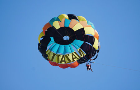 A colorful parachute with a tourist on the sky near Mazatlan, Mexicoの写真素材