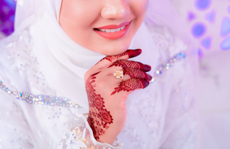 A Malaysian bride with her wedding ring and hand decorated with henna tattooの写真素材