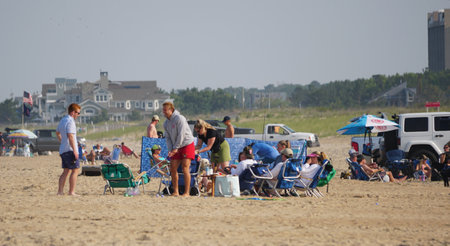 Rehoboth Beach, Delaware, U.S.A - June 18, 2023 - A group of family hanging out on the beach near North Shoresのeditorial素材