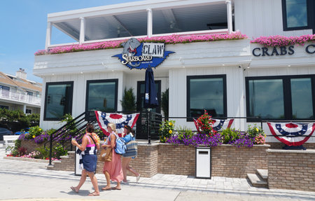 Dewey Beach, Delaware, U.S.A - July 4, 2023 - People walking in front of the famous Starboard Claw restaurant and barのeditorial素材