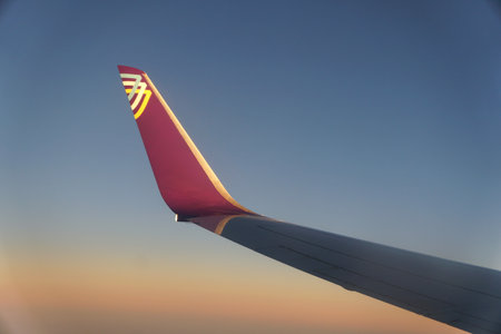 Wilmington, Delaware, U.S.A - November 11, 2023 - The side view of the wing of Avelo Airlines plane in the skyのeditorial素材