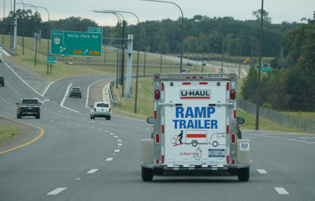 Apopka, Florida, U.S.A - November 12, 2023 - A U-Haul ramp trailer truck moving on the highwayのeditorial素材
