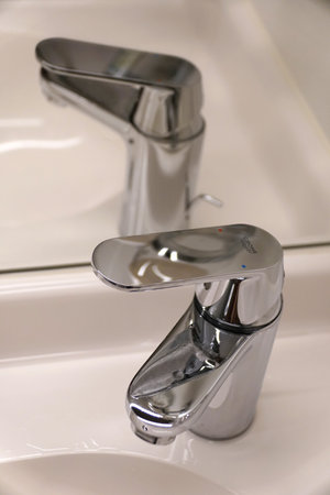 Miami, Florida, U.S.A - February 18, 2024 - A Grohe stainless steel bathroom faucet on a white sinkのeditorial素材