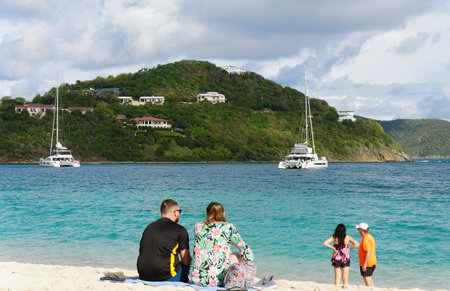 St John, U.S Virgin Islands - February 21, 2024 - Tourists enjoying the beautiful beach on the Long Bay Beef Island on a sunny dayのeditorial素材