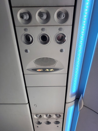 Essington, Pennsylvania, U.S.A - February 18, 2024 - The top interior of the passenger's plane, including the top lights, buttons to call the flight attendant and adjustable air-conditioner valveのeditorial素材