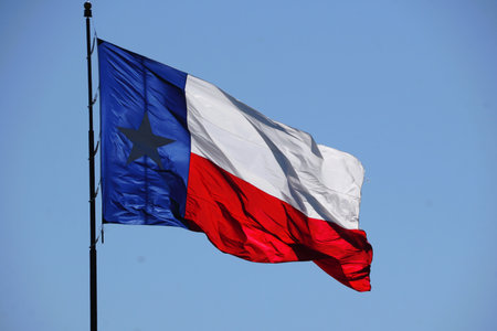 The red, white and blue State of Texas flag moving on a pole