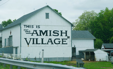 Strasburg, Pennsylvania, U.S.A - May 21, 2024 - The big Amish Village sign on the white building
