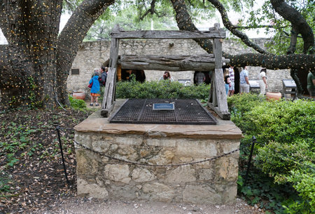 San Antonio, Texas, U.S.A - April 9, 2024 - The old and historic Alamo well under the oak treeのeditorial素材