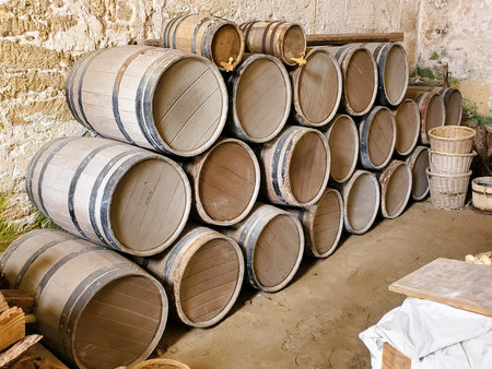 A pile of brown barrels arranged against the wall