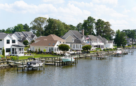 Rehoboth Beach, Delaware, U.S.A - June 23, 2024 - The view of the luxury waterfront homes with boat lifts by the bayのeditorial素材