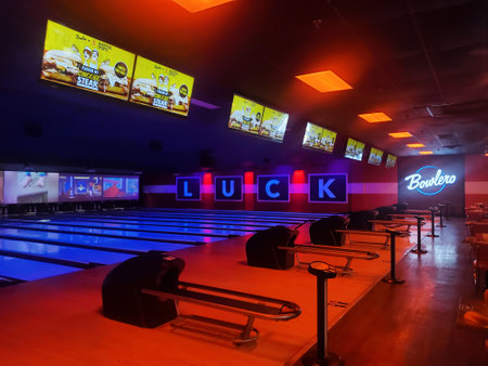 Wilmington, Delaware, U.S.A - April 20, 2024 - The illuminated lanes and surrounding of the Bowlero bowling alleyのeditorial素材