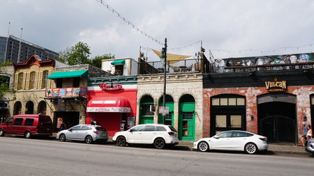 Austin, Texas, U.S.A - April 9, 2024 - The variety of restaurants and stores on East 6th Street in the downtown areaのeditorial素材