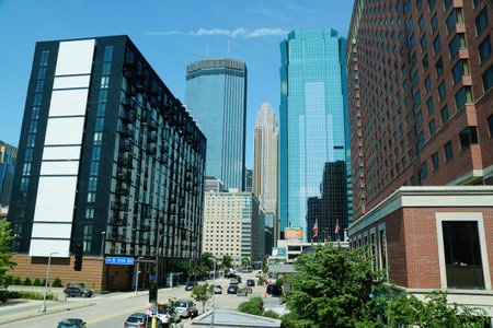 Minneapolis, Minnesota, U.S - July 13, 2024 - The view of the tall modern buildings, apartments, hotels and traffic on S 11th Street on a sunny dayのeditorial素材