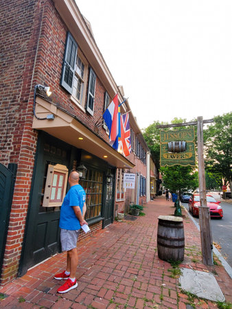 New Castle, Delaware, U.S.A - July 28, 2024 - A visitor checking out the menu of Jessop Tavern, located on the historic Old New Castle areaのeditorial素材
