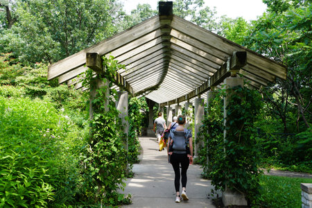 Visitors walking underneath the Pergola Garden of Minnehaha Falls near Minneapolis, Minnesota, U.S.Aの写真素材