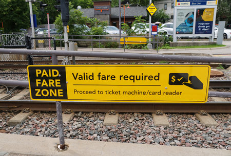 Minneapolis, Minnesota, U.S.A - July 12, 2024 - The paid fare zone sign for the Metro Transit train...
