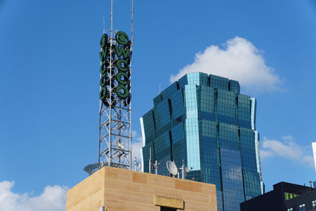 Minneapolis, Minnesota, U.S.A - July 12, 2024 - The green WCCO antenna and sign of the local TV station of CBS Minnesota overlooking ATT Towerのeditorial素材