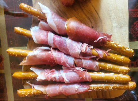 Appetizing pretzel sticks, each wrapped with a delicate layer of prosciutto.の写真素材
