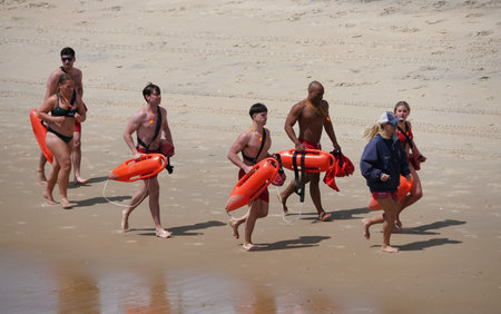 Ocean City, Maryland, U.S.A - May 23, 2025 - A line of lifeguards, equipped with rescue floats,...