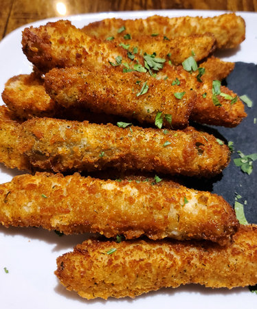 A plate piled high with perfectly fried pickles, ready to be devoured.の写真素材