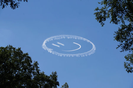 A smiley face etched into the sky by a jet's contrail against a clear blue backdrop in Wilmington,...