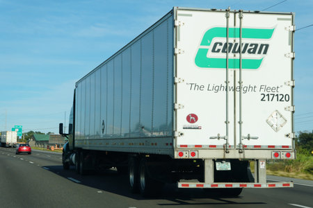 Lakeland, Florida, U.S.A - Nov 10, 2025 - A rear view of Cowan semi-truck labeled 'The Lightweight Fleet' transports regulated materials on the highwayのeditorial素材