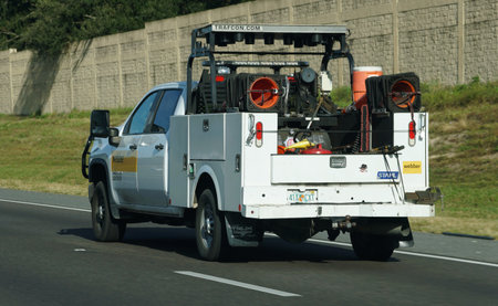 Lakeland, Florida, U.S. - Nov 10, 2025 - A rear view of Webber utility truck equipped for highway...