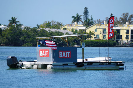 Anna Maria Island, Florida, U.S.A - March 26, 2026 - The floating bait shop on a pontoon platform with large BAIT signs, open flag, and waterfront backdrop.のeditorial素材