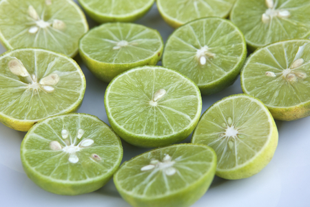 Fresh ripe lemons on a white plate.の写真素材