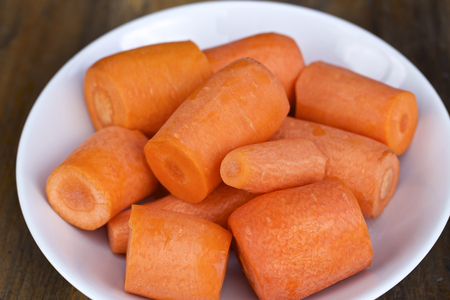 Sliced carrots in a white plate on the table.の写真素材