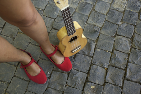 woman standing next to ukuleleの写真素材