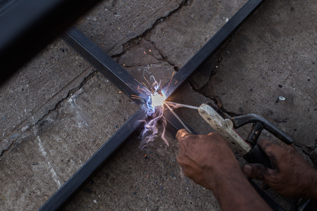 Iron welding with bright light and smoke at manufacturingの写真素材