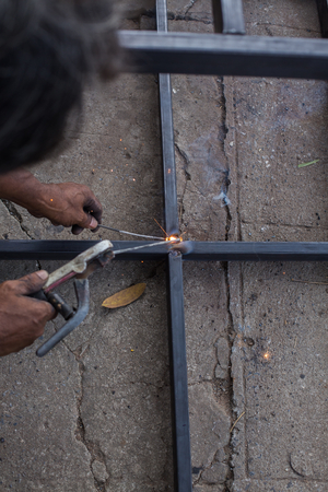 Iron welding with bright light and smoke at manufacturing