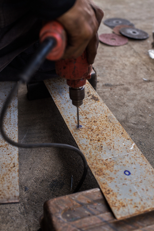 Construction workers were using a drill to create jobs.