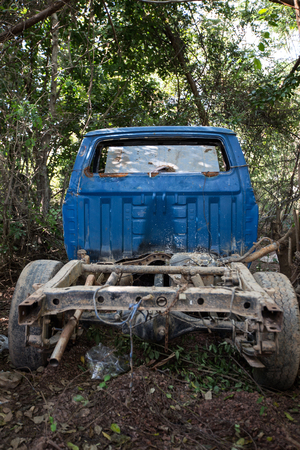 Old damaged rusty car wreck abandoned in the grassの写真素材