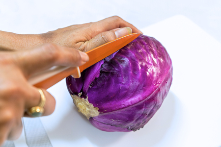 Cut red cabbage isolated on whiteの写真素材